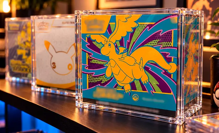 Pokémon Elite Trainer Boxes in Slab Bunker acrylic cases on a lit shelf